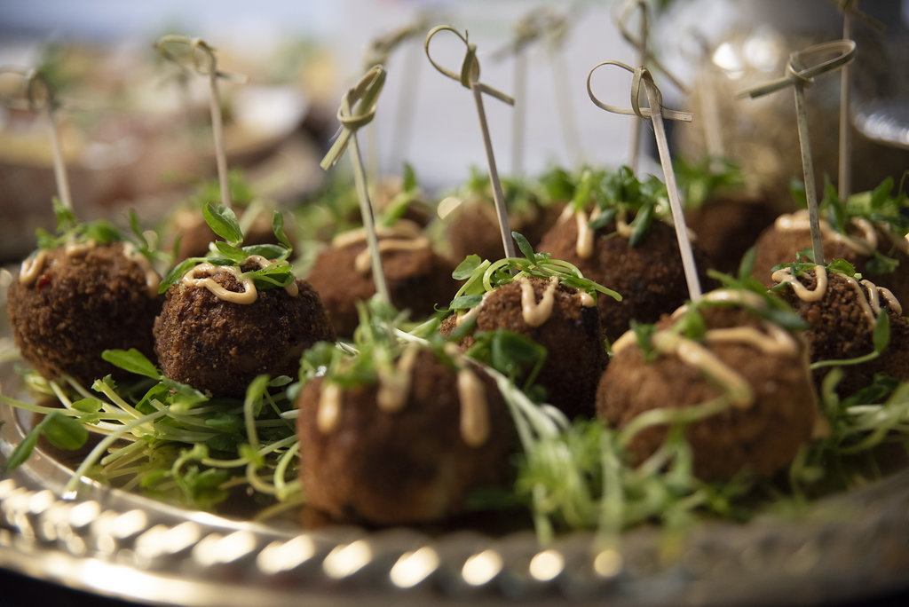 plate of meatballs with toothpicks in them, nicely plated for a catering event