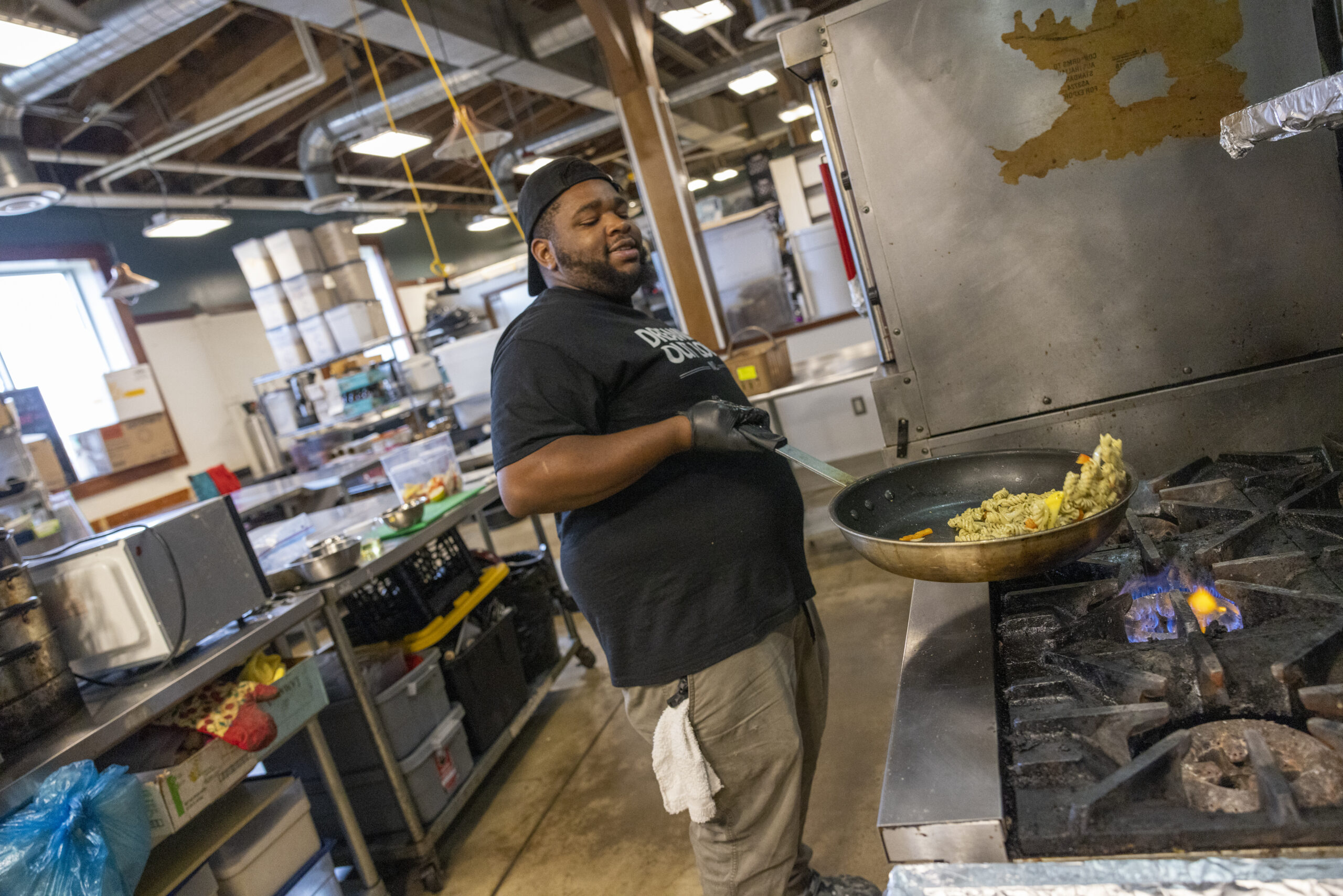 person cooking food and smiling