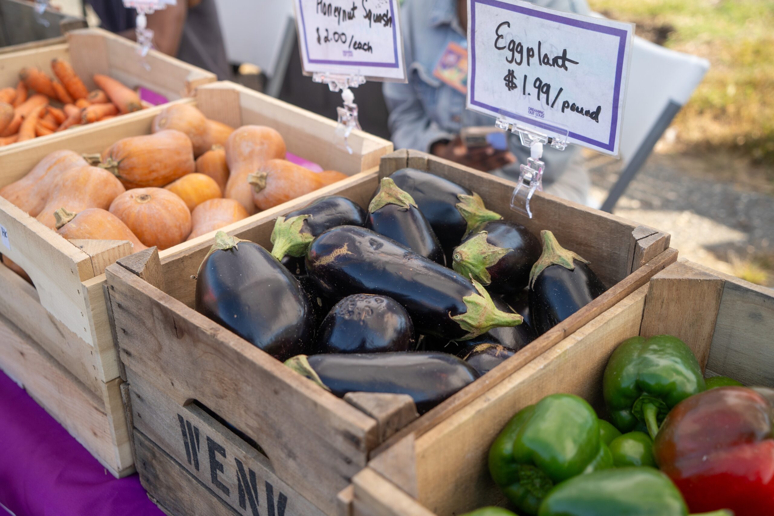 outdoor market with boxes of produce on a table