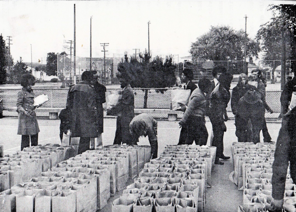 community leaders preparing bags of food for pickup