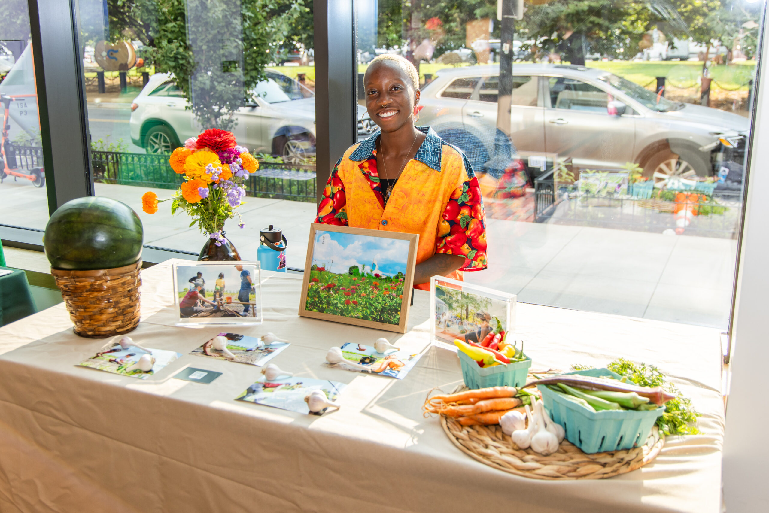 Person standing at a table of promotional items for a business