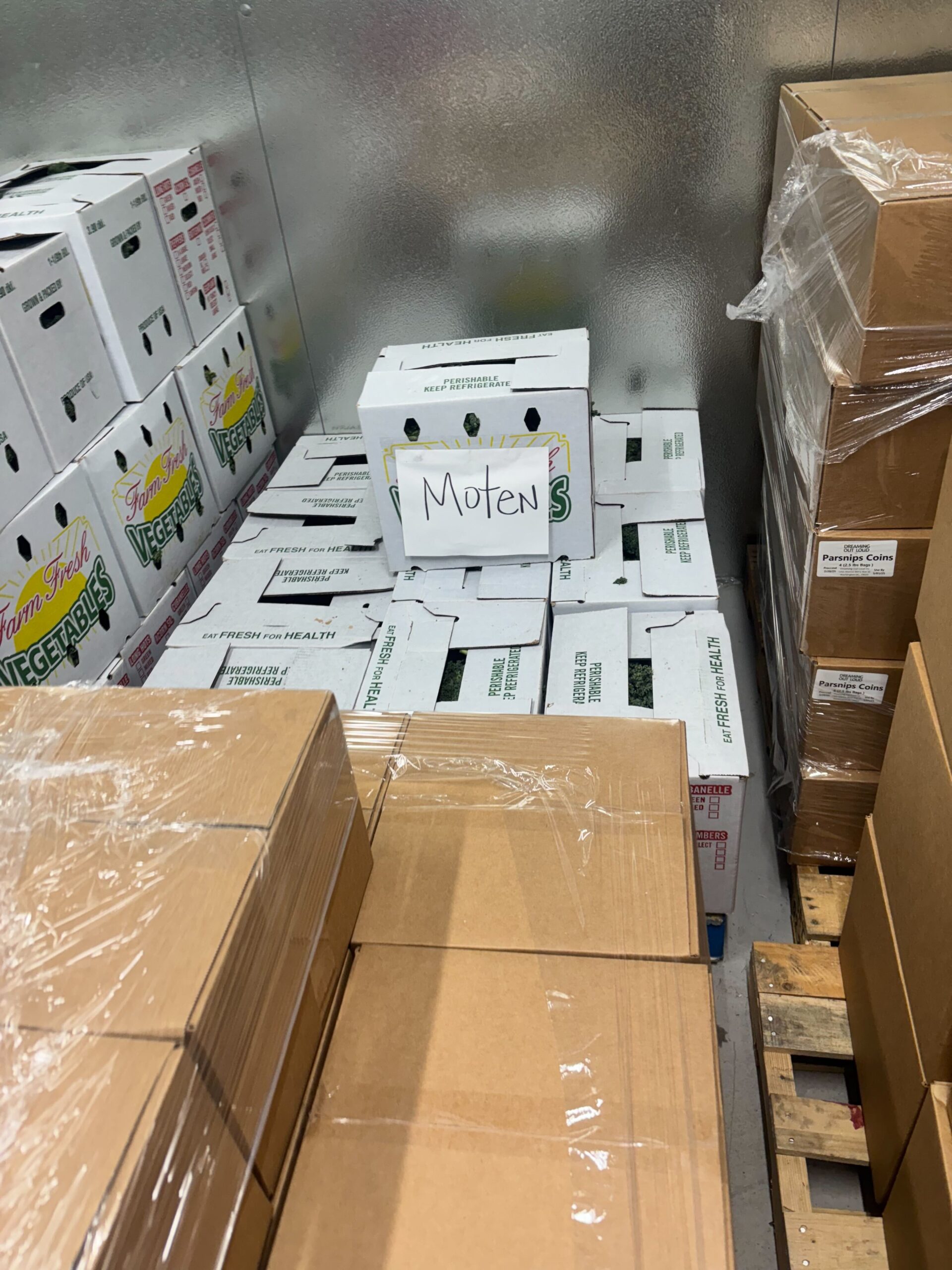 White and brown boxes stacked in a cooler