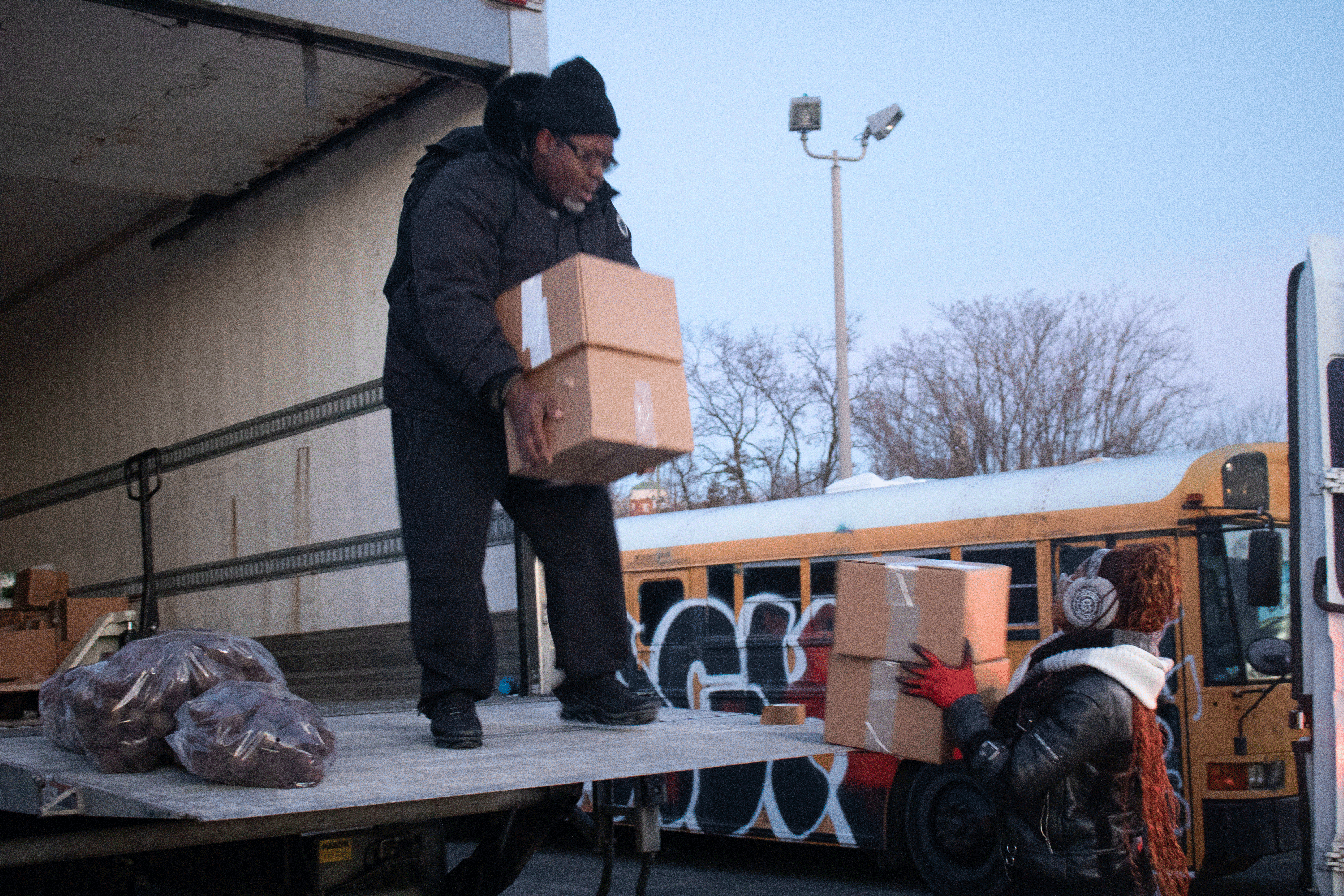 man and woman loading boxes into a delivery truck